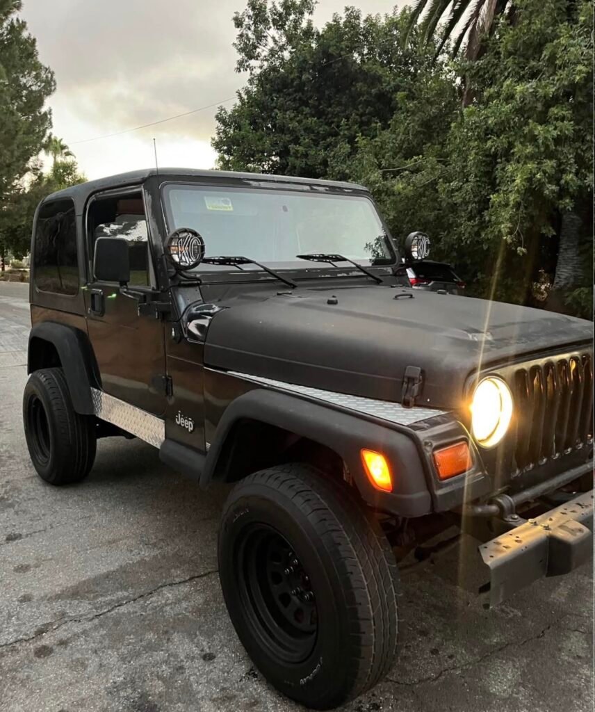 Matte black Jeep Wrangler TJ with soft top and KC off-road lights – used OEM parts 1997-2006