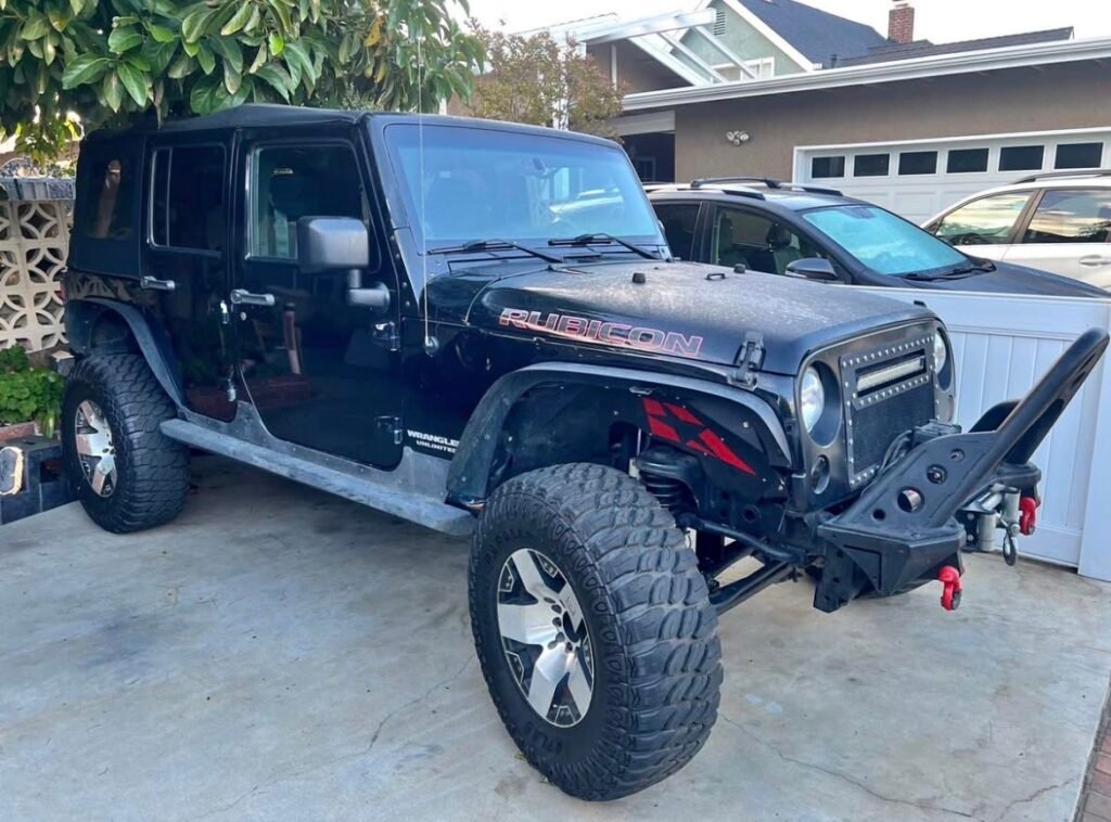 Lifted black Jeep Wrangler JKU Rubicon Unlimited 4-door – used OEM parts 2007-2018