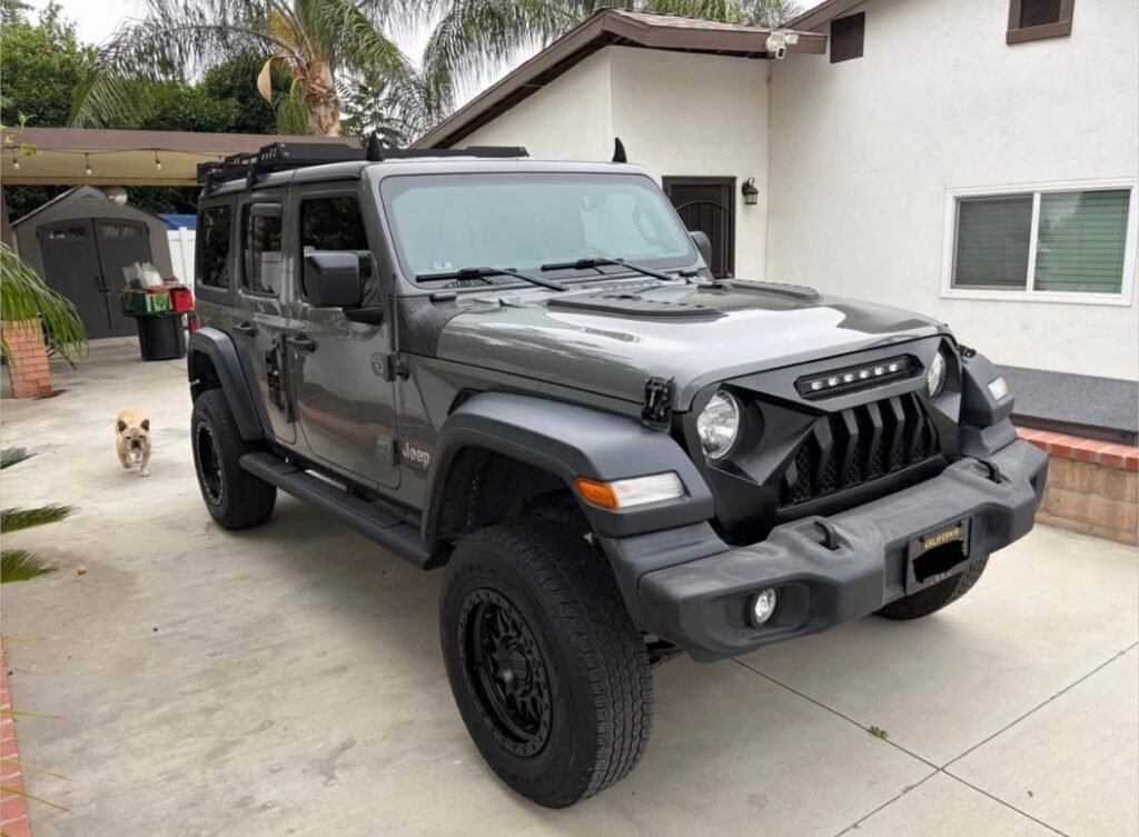 Grey Jeep Wrangler JLU Unlimited with aftermarket grille and LED lights – 2018-present
